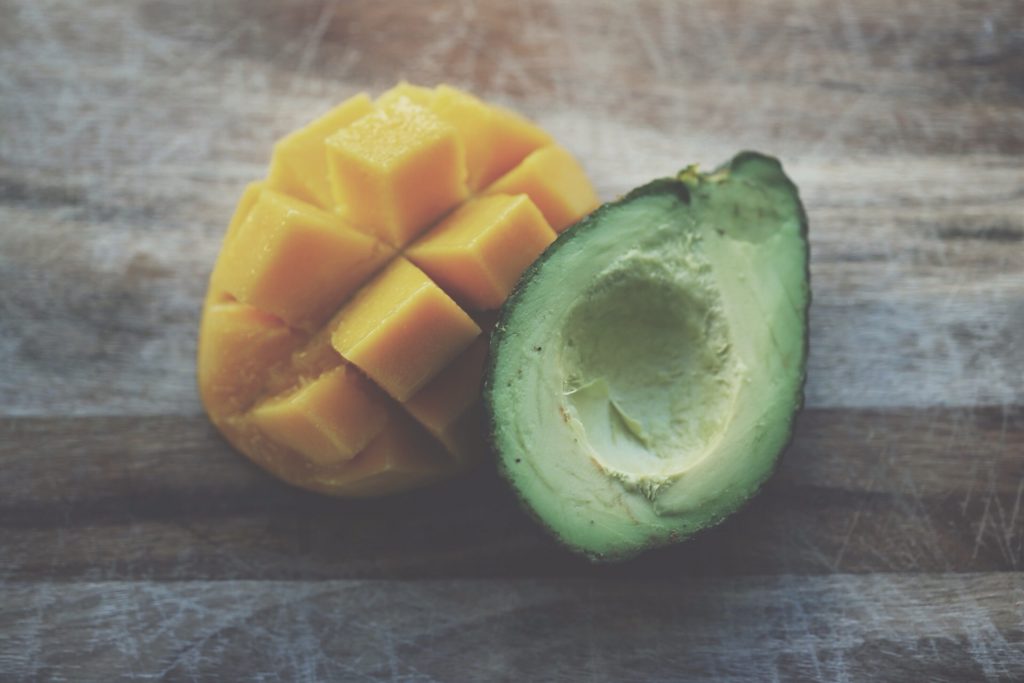 A raw mango and avocado cut open