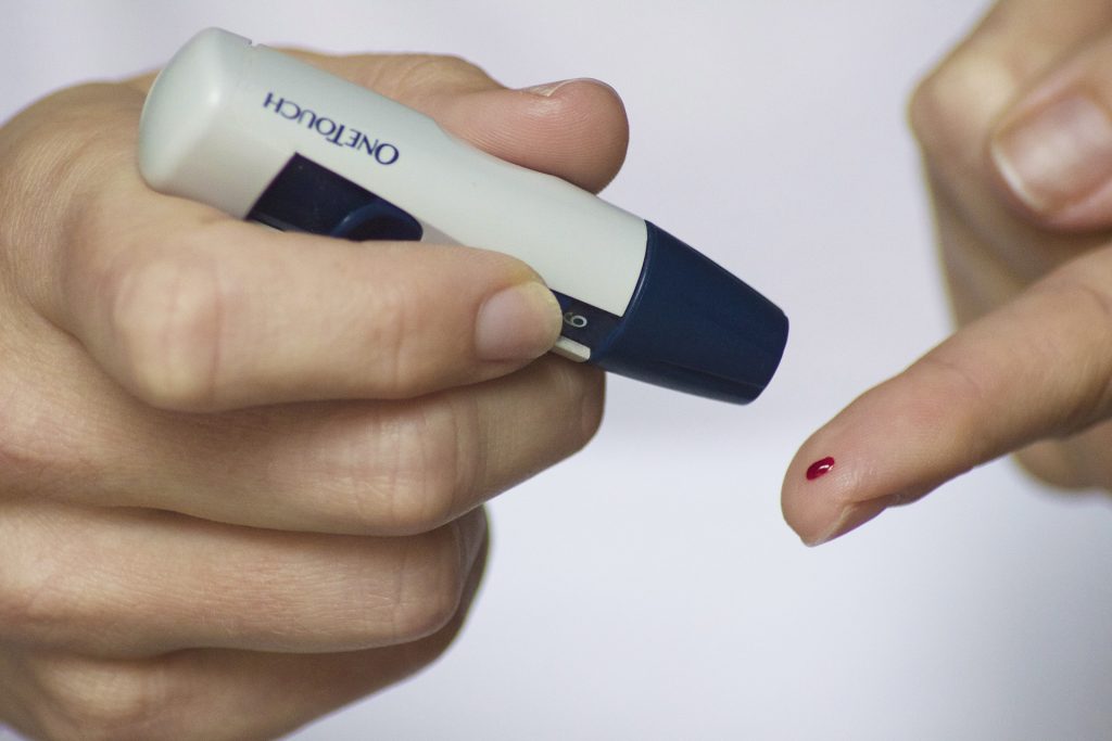 A woman testing her blood sugar levels